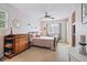 Cozy bedroom featuring soft pink walls, carpeted floors, and a decorative dresser at 2244 Fenton St, Edgewater, CO 80214