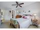 Bright bedroom featuring a large bed, ceiling fan and access to an ensuite bathroom at 2244 Fenton St, Edgewater, CO 80214