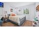 Cozy bedroom with a colorful bed, a sunny window, and unique decor at 2244 Fenton St, Edgewater, CO 80214