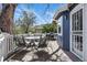 Outdoor deck area with charming dining set and grill attached to a two-story blue home at 2244 Fenton St, Edgewater, CO 80214