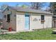 Detached garage with a light blue door and a few plants and decorative objects attached to it at 2244 Fenton St, Edgewater, CO 80214