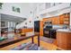 Open floor plan featuring kitchen with black appliances, wooden cabinets, and dining area at 2244 Fenton St, Edgewater, CO 80214