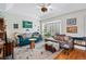 Bright living room with hardwood floors, comfortable seating, and bay window at 2244 Fenton St, Edgewater, CO 80214
