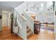 Bright staircase landing with white railings and views into the kitchen and dining area at 2244 Fenton St, Edgewater, CO 80214