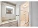 Well-lit bathroom featuring a vanity and a shower with glass doors at 360 Upham St, Lakewood, CO 80226