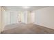 Open carpeted bedroom featuring standard closet and a bathroom at 360 Upham St, Lakewood, CO 80226