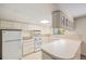 Traditional-style kitchen with a full set of appliances, light cabinets and a peninsula at 360 Upham St, Lakewood, CO 80226