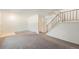 Neutral living area with stairs to the upper level, next to the front door at 360 Upham St, Lakewood, CO 80226