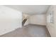 Bright living room featuring neutral carpet and stairs leading to the upper level at 360 Upham St, Lakewood, CO 80226