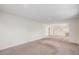 Spacious room with neutral carpet, and kitchen in background at 360 Upham St, Lakewood, CO 80226