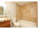 Bathroom featuring a vanity with tile countertop, toilet and tiled shower-tub combo at 3100 S Federal Blvd # 307, Denver, CO 80236
