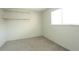 Bright bedroom with built-in shelving and a window for natural light at 3100 S Federal Blvd # 307, Denver, CO 80236