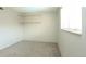 Carpeted bedroom with built-in shelving and a window for natural light at 3100 S Federal Blvd # 307, Denver, CO 80236