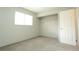 Bedroom featuring neutral carpet, a closet with shelving and a window for natural light at 3100 S Federal Blvd # 307, Denver, CO 80236