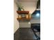 Modern kitchen includes sleek countertops, stainless appliances, and floating wood shelves at 3100 S Federal Blvd # 307, Denver, CO 80236