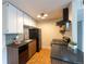 This kitchen includes wooden cabinets, sleek countertops, and modern appliances at 3100 S Federal Blvd # 307, Denver, CO 80236