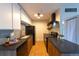 Open kitchen with sleek countertops and wood cabinets, tile backsplash and modern appliances at 3100 S Federal Blvd # 307, Denver, CO 80236