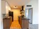 Functional kitchen featuring wood cabinets, tile backsplash and modern appliances at 3100 S Federal Blvd # 307, Denver, CO 80236