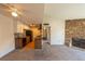 Living room view showcasing a stone fireplace and open floor plan to the kitchen at 3100 S Federal Blvd # 307, Denver, CO 80236