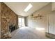 Bright living room with a stone fireplace, sliding glass doors, and a skylight at 3100 S Federal Blvd # 307, Denver, CO 80236