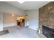 Open-concept living room featuring a stone fireplace and a seamless transition to the kitchen at 3100 S Federal Blvd # 307, Denver, CO 80236