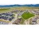 A high aerial view shows a modern neighborhood with large lots, green spaces, and mountain views at 17850 W 94Th Dr, Arvada, CO 80007