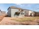 View of a home's backyard with a covered patio and a fenced-in yard filled with decorative stones at 17850 W 94Th Dr, Arvada, CO 80007