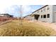 Spacious backyard featuring a covered patio, lush green lawn, and a classic wooden fence at 17850 W 94Th Dr, Arvada, CO 80007