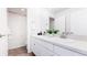Bathroom featuring double sinks, white cabinets, and a shower-tub combination at 17850 W 94Th Dr, Arvada, CO 80007