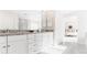 Bathroom vanity with granite counters, dual sinks, white cabinetry and a luxurious shower at 17850 W 94Th Dr, Arvada, CO 80007