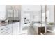 Well-lit bathroom featuring dual sinks, a soaking tub, and a separate glass-enclosed shower at 17850 W 94Th Dr, Arvada, CO 80007