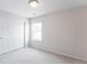 Empty bedroom featuring a window and a closet space at 17850 W 94Th Dr, Arvada, CO 80007