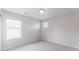 This bedroom features neutral carpet, paint and natural light from two different windows at 17850 W 94Th Dr, Arvada, CO 80007
