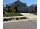 Two-story home with a two-car garage, well-manicured lawn, and a beautifully landscaped yard at 17850 W 94Th Dr, Arvada, CO 80007