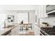 Open-concept kitchen featuring granite counters, a dining area, stainless steel appliances, and ample cabinet space at 17850 W 94Th Dr, Arvada, CO 80007