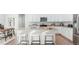 Bright kitchen features stainless steel appliances, granite countertops and a large island with seating at 17850 W 94Th Dr, Arvada, CO 80007
