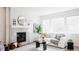 Bright living room featuring a fireplace, large windows, and modern decor for a comfortable and inviting space at 17850 W 94Th Dr, Arvada, CO 80007