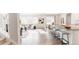 Inviting living space showcasing an open-concept layout connecting the kitchen, dining, and living areas at 17850 W 94Th Dr, Arvada, CO 80007