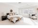 Bright main bedroom features neutral colors, large windows, and a tray ceiling at 17850 W 94Th Dr, Arvada, CO 80007