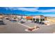 A large parking lot filled with cars in front of commercial buildings under a sunny sky at 17850 W 94Th Dr, Arvada, CO 80007