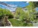 Lush backyard featuring a well-manicured lawn and mature trees with back of house at 5400 Heatherton Ln, Highlands Ranch, CO 80130