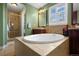 Bright bathroom featuring a large soaking tub, tiled shower, and vanity with cabinet and sink at 5400 Heatherton Ln, Highlands Ranch, CO 80130