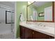 Bathroom featuring double sinks, white countertops, and a glass-enclosed shower at 5400 Heatherton Ln, Highlands Ranch, CO 80130