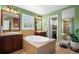 Luxurious bathroom with a soaking tub, dual vanities, natural light and a walk-in closet at 5400 Heatherton Ln, Highlands Ranch, CO 80130
