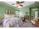 Bedroom with a ceiling fan, tray ceiling, a quaint sitting area and an elegant dresser at 5400 Heatherton Ln, Highlands Ranch, CO 80130
