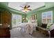 Well-lit bedroom with French doors, a ceiling fan, and a decorative armoire for storage at 5400 Heatherton Ln, Highlands Ranch, CO 80130