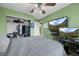 Green bedroom featuring a ceiling fan, closet and multiple screens for entertainment and work at 5400 Heatherton Ln, Highlands Ranch, CO 80130
