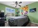 Stylish bedroom featuring large window, providing ample natural light, complemented by modern art pieces at 5400 Heatherton Ln, Highlands Ranch, CO 80130