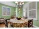 Inviting dining room featuring a decorative chandelier, window views, and a floral-covered dining table at 5400 Heatherton Ln, Highlands Ranch, CO 80130