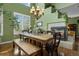 Charming dining area with a fireplace, large windows, and a rustic wooden table with bench seating at 5400 Heatherton Ln, Highlands Ranch, CO 80130